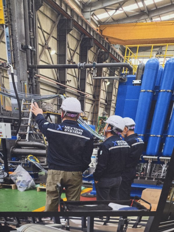 NextDyn Systems personnel reviewing industrial production equipment